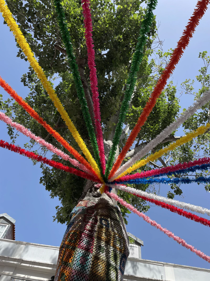 Colorful decorations attached to a tree in the Alfama district